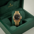 Rolex men's quartz luxury watch in a green box with a black dial and gold band, showcasing elegance and sophistication.